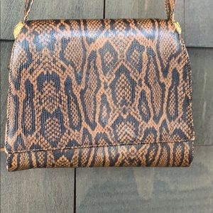 Embossed faux snake handbag.